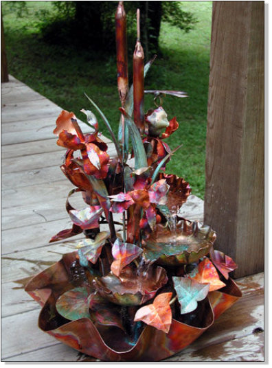 Four tiered copper fountain with three irises