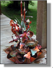 Four tiered copper fountain with three irises